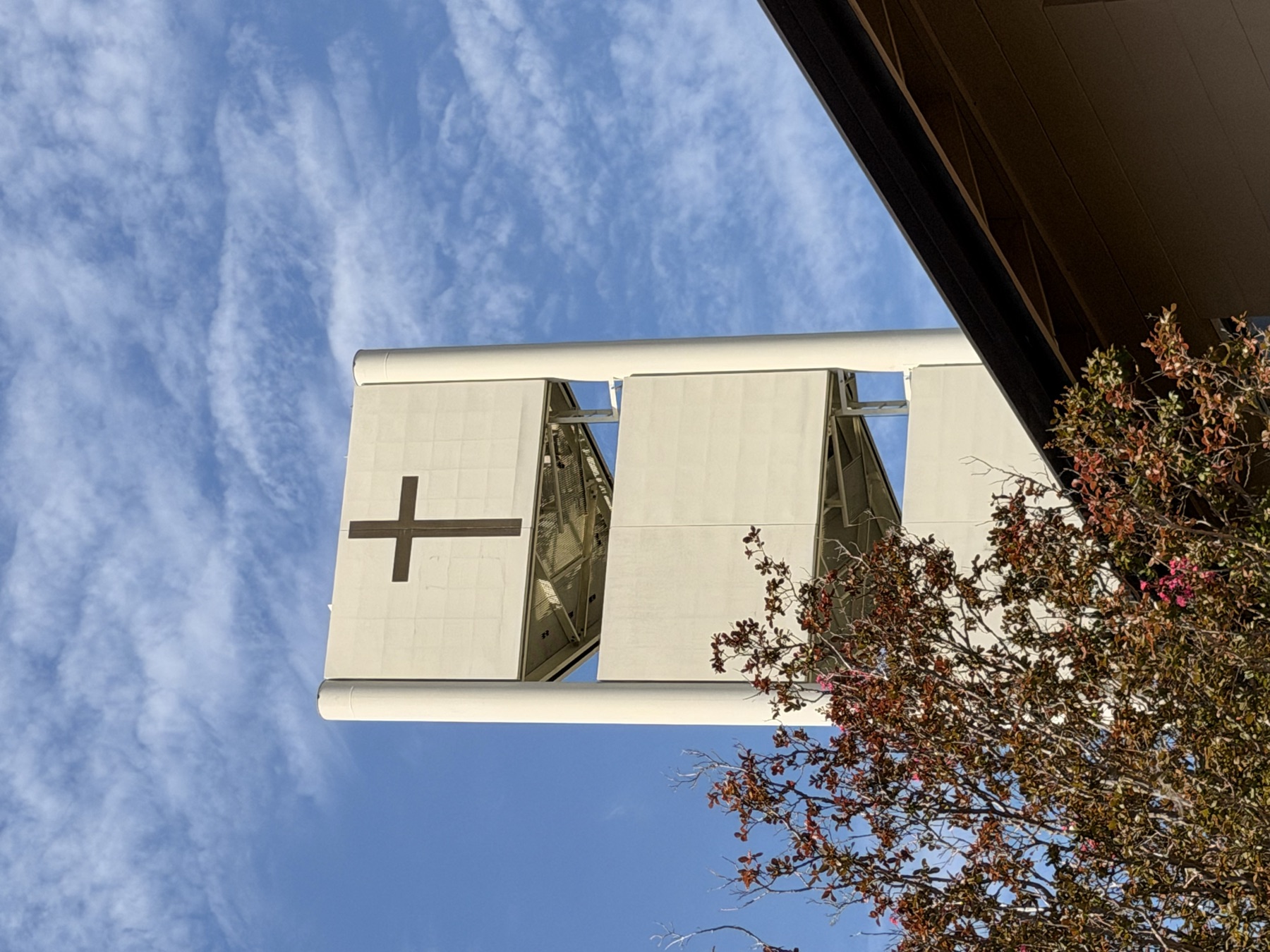 Church exterior with cross against blue sky