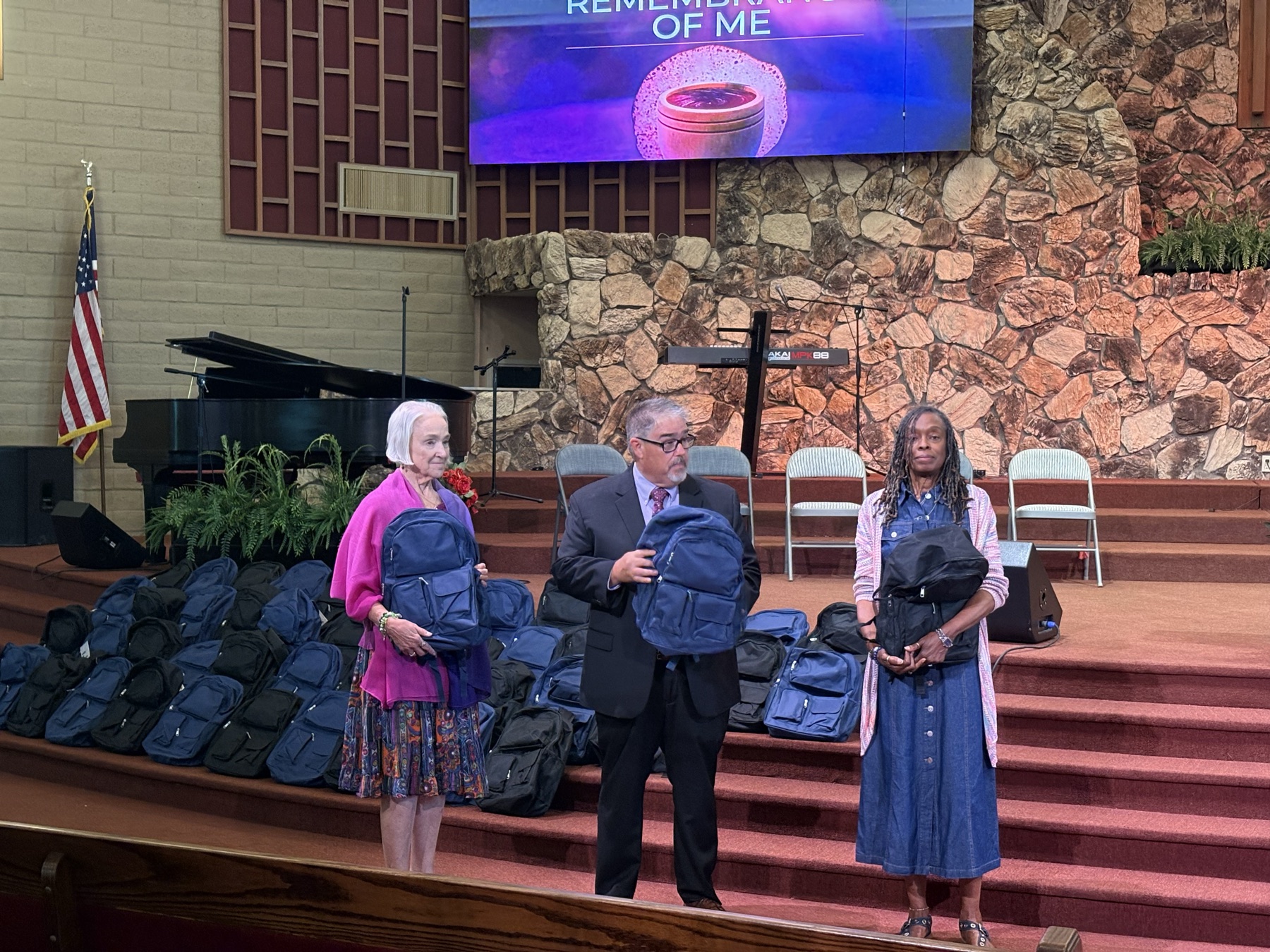 Church members handing out backpacks at a past community outreach event