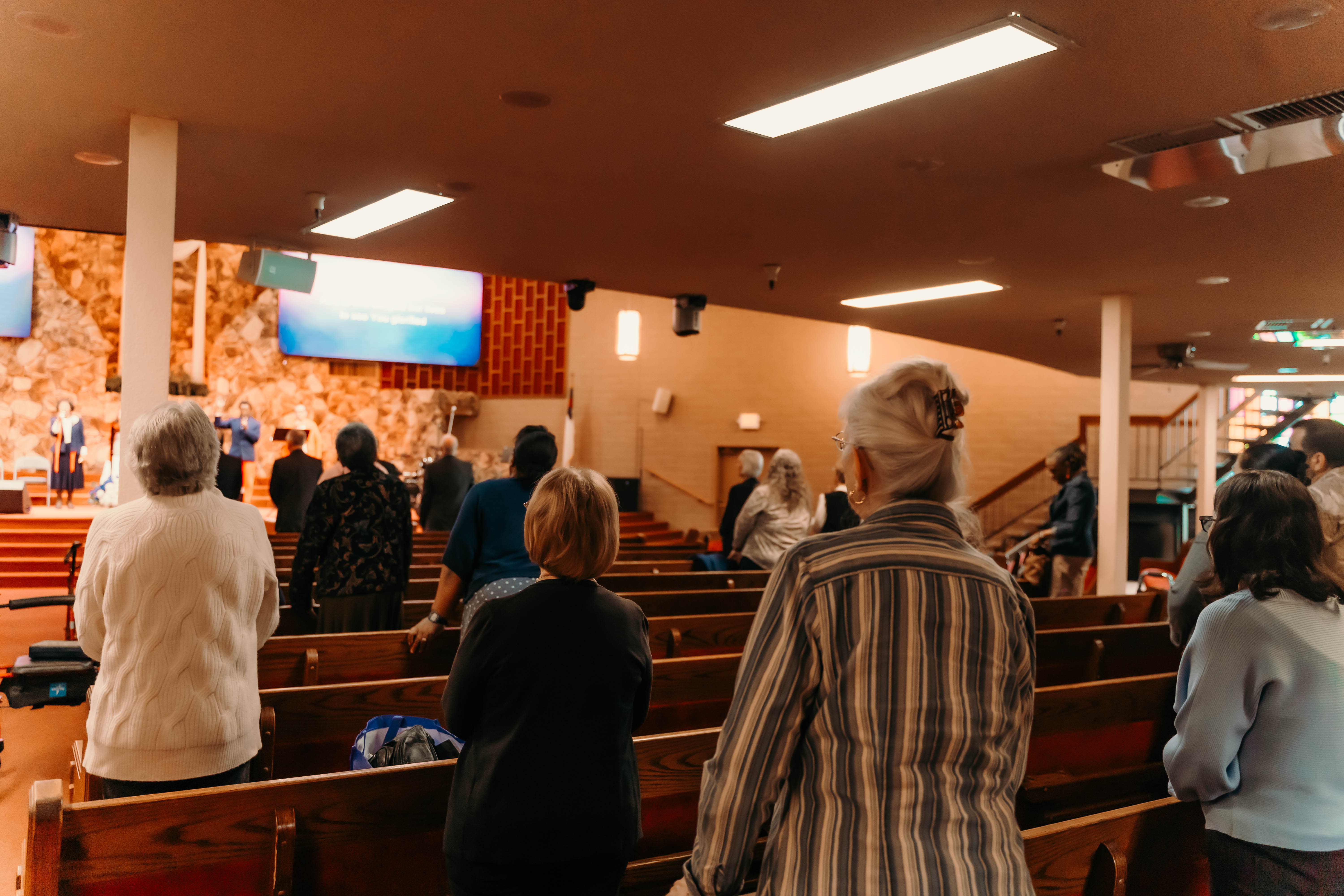 Older adults gathered together in the sanctuary during worship