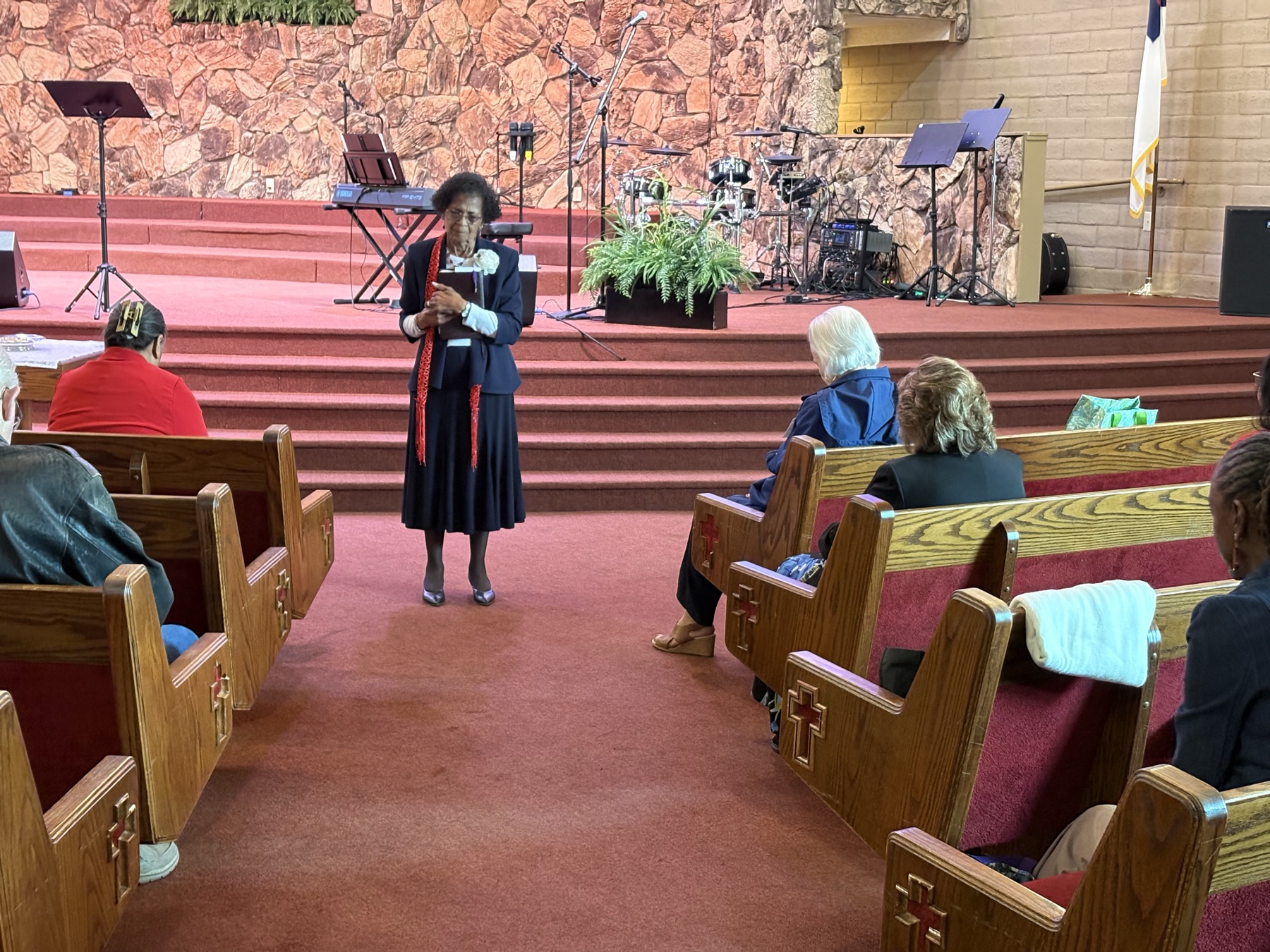 Woman sharing with the congregation in the sanctuary